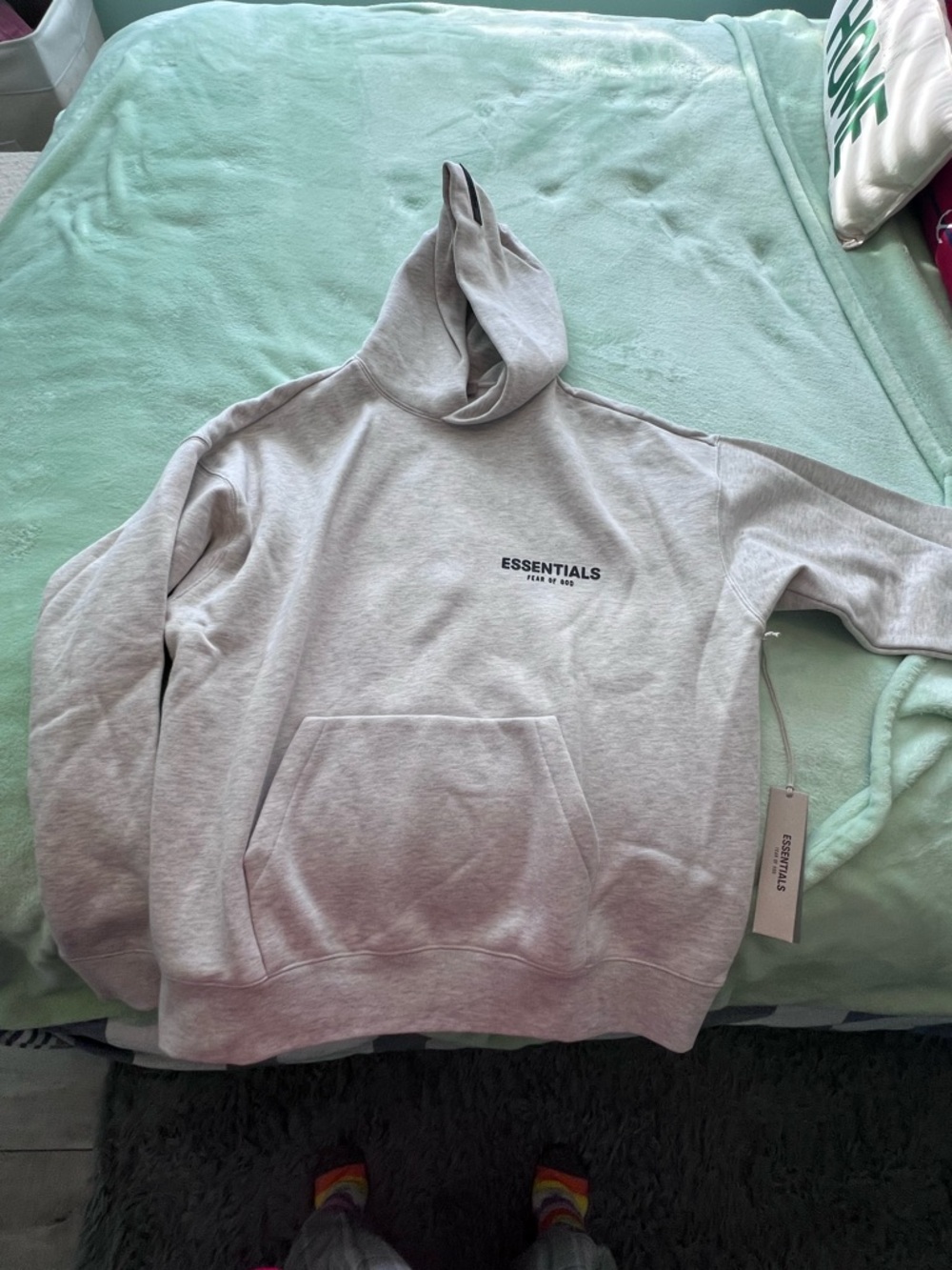 Fear of God Essentials Light Oatmeal Hoodie.
